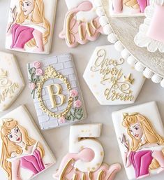 princess themed cookies are arranged on a table