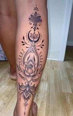 a woman's leg with tattoos on it, and a flower in the center