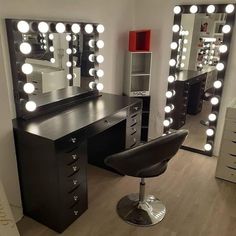 a vanity with lights on it and a chair in front of the mirror that is lit up