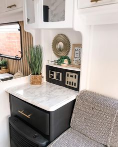 a kitchen area with a stove, microwave and counter top in the back of a trailer