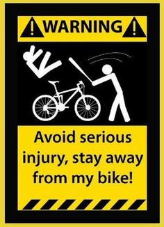 a warning sign with an image of a person pushing a bicycle