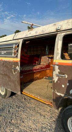 an old van with the door open and it's interior painted rusted brown