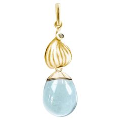 This Fig drop pendant necklace is made of 18 karat yellow gold and features a detachable cabochon natural topaz. The gemstone drop is open to the light, making it sparkle. This collection was featured in Vogue Ukraine. The idea for this collection came from Berlin-based artist Polya Medvedeva, who was inspired by the sweet and fresh fragrances of figs. The collection has become a symbol for anyone who loves fragrances or sunny places where figs grow. The design of the shining gold fig pendant makes it a contemporary piece of jewelry, while the simplicity of its lines and the large dark gemstone give it a grungy look. In ancient myths, the fig tree is considered a sacred tree. The sugar fig fruit was also known as the forbidden fruit in the Bible, and fig leaves were used as the first cloth Vogue Ukraine, Oyster Shell Crafts, Topaz Yellow, Ancient Myths, Drop Pendant Necklace, One Clothing, Fresh Fragrances, Oyster Shell, The Shining