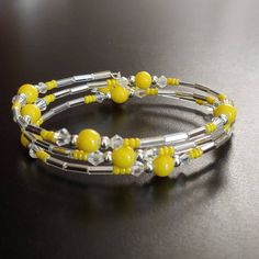 3 Loops Of Acrylic Yellow 6mm Round Beads, With 3mm Clear Crystals, 11/0 Seed Beads, And Silver Bugle Beads. Recommend For A 6-8" Wrist, But If You Like Your Bracelets Close-Fitting, Bigger Is Okay, Too! Brand New, Never Worn Nwt. Handmade By Me, The Sparkliefiend! Memory Wire Is A Steel Wire That “Remembers” Its Shape. Items Made With This Material Do Not Require A Clasp; They Will Stay Gently Closed Around The Wearer After Wrapping It Around The Wrist. Adjustable Yellow Oval Beaded Jewelry, Memory Wire Bracelets Ideas, Memory Wire Wrap Bracelets, Bracelets Ideas, Memory Wire Bracelet, Wire Wrapped Bracelet, Memory Wire Bracelets, Bugle Beads, Wire Bracelet