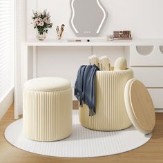 a white table with two stools and a mirror on the wall in front of it