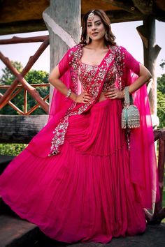 Fuchsia pink lehenga with attached cancan with gathered and tiered silhouette. Comes with thread, cutdana and sequin floral embroidered padded blouse, separate drape dupatta and a cape. - Aza Fashions Pink Ruffled Sharara For Festivals, Floor-length Pink Lehenga With Ruffles, Pink Floor-length Ruffled Lehenga, Pink Ruffled Lehenga For Festivals, Pink Floor-length Sharara With Ruffles, Pink Ruffled Sharara For Wedding, Pink Ruffled Choli For Wedding, Pink Ruffled Sets For Reception, Festive Pink Ruffled Choli