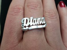 a woman's hand with a silver ring that says dana