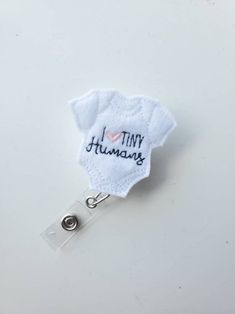 a badge that says i love tiny humans