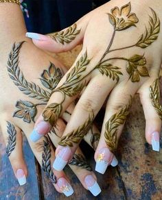 two hands with hendi designs on them