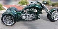 a green motorcycle is parked on the street