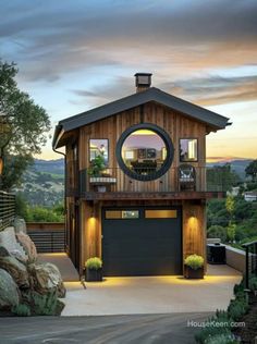 a house that has a lot of windows on the front and side of it with a large circular window