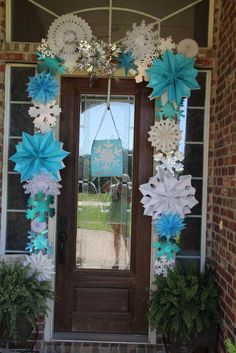 a front door decorated with paper snowflakes