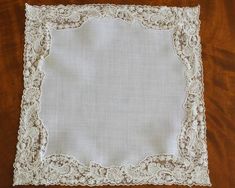 a white doily sitting on top of a wooden table