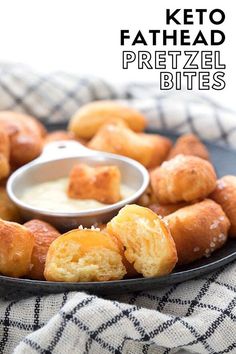 a black plate topped with fried pretzel bites