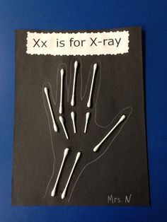 an x is for x - ray hand made out of toothpicks on a piece of black paper