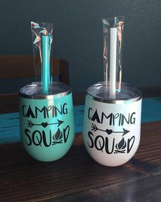 two tumblers with the words camping soul on them are sitting on a wooden table