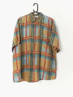 90s vintage plaid short sleeve silk shirt in orange-red, blue and green. Features one front pocket with button closure. Our recommended size: Large Label Says: 24/24 L Condition: very good Material: silk Measurements in inches: Pit to pit: 25 Shoulders: 21.5 Front length: 32 Back length: 32 Sleeve length: 10 We've provided garment measurements and we recommend that you compare our measurements to a similar item of your own to ensure good fit. Measurements are taken flat and doubled for waist and Plaid Short Sleeve Summer Shirt, Plaid Short Sleeve Camp Shirt With Relaxed Fit, Plaid Camp Collar Shirt For Summer, Summer Plaid Camp Shirt With Camp Collar, Summer Plaid Short Sleeve Camp Shirt, Plaid Short Sleeve Shirt With Relaxed Fit, Retro Plaid Short Sleeve Shirt, Retro Short Sleeve Plaid Shirt, Plaid Short Sleeve Shirt With Pockets