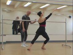 two men and a woman are practicing ballet