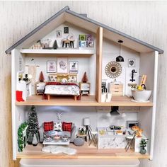 a doll house with furniture and decorations on the shelves