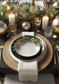 a black and gold christmas table setting with greenery, candles and napkins on it