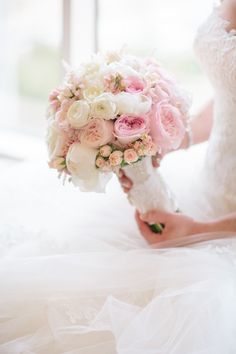 a bride holding a bouquet of flowers in her hand