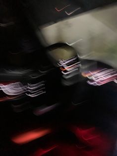 blurry photograph of cars in motion on the road at night with red and white lights