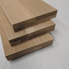 three pieces of wood are stacked on top of each other in order to look like they have been cut together