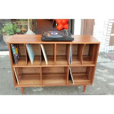 a record player on top of a wooden shelf