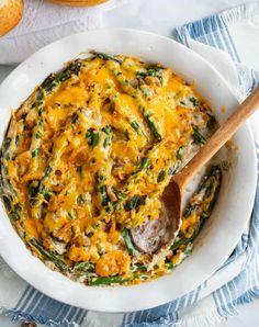 a casserole dish with cheese and asparagus in it on a white plate