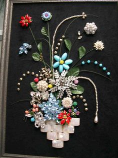 an art piece with flowers and pearls on it