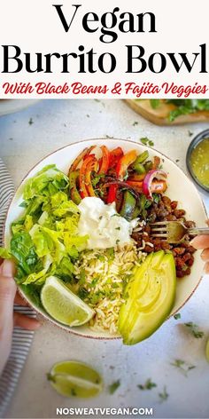 a person holding a plate with salad on it and the title vegan burrito bowl