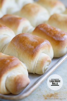 bread rolls are lined up on a baking sheet and ready to be baked in the oven