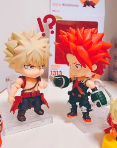 two anime figurines are on display with question marks