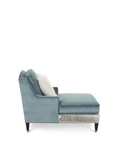 a blue chaise lounge chair with white pillows