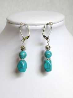 "These earrings are made with magnesite that has been dyed a turquoise blue. The shape of the sides of the larger bead is a diamond shape.  This bead is 1/2 inch long (about 12mm). The top bead is an 8mm round. Silver plated metals were used throughout These earrings hang 1 and 1/4\" from the loop of the silver plated lever back ear wires. They will be slipped into an organza bag and shipped in a bubble mailer." Southwest Style, Bubble Mailer, Lovely Jewellery, The Loop, Diamond Shape, Organza Bags, Turquoise Blue, Ear Wires, Diamond Shapes