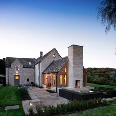 a large house sitting on top of a lush green field