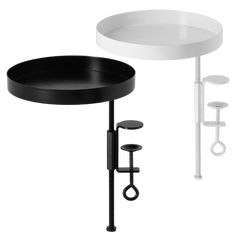 a black and white sink next to a stand with two stools on each side