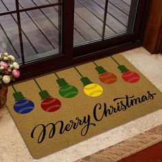 a door mat that says merry christmas with baseballs and lights on it next to a potted plant