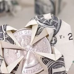 an origami heart made out of twenty dollar bills is shown in this image