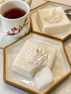 three plates with desserts on them and a cup of tea in the middle one