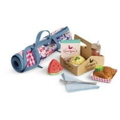 an open picnic box with food and utensils