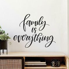 a wall decal with the words family is everything in black on it, next to a