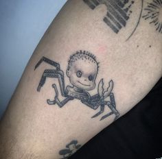 a man with a spider tattoo on his arm