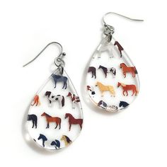 "Horse patterned tear drop shape earrings made of clear acrylic. Stainless steel ear wires are non tarnishing for long wear lightweight for comfort of long wear.  Whether you're a dedicated equestrian, a farmer, a horse rescuer, or a fan of horse shows and races, these earrings are a must-have addition to your jewelry collection. Crafted from high-quality printed acrylic, these earrings are lightweight and comfortable to wear all day long. The teardrop shape beautifully frames your face, while t Clear Teardrop Earrings, Pink Hangers, Race Day Outfits, Horse Earrings, Equestrian Gifts, Horse Pattern, A Farmer, Horse Lovers, Christmas Stocking Stuffers