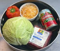 cabbage, cheese, tomatoes, and other ingredients are in a bowl on the table