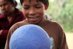 a young boy holding a blue frisbee in his hands