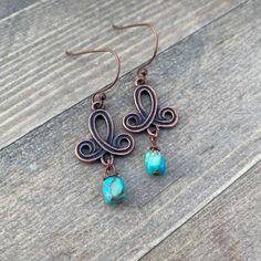 the earrings are made with copper wire and turquoise beads