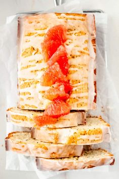 slices of bread with oranges and cream cheese on them sitting in a plastic wrapper