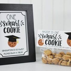 there is a sign and some cookies in front of the picture frame that says, one smart cookie