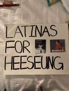 a sign that says latinas for heeseung with pictures of women on it